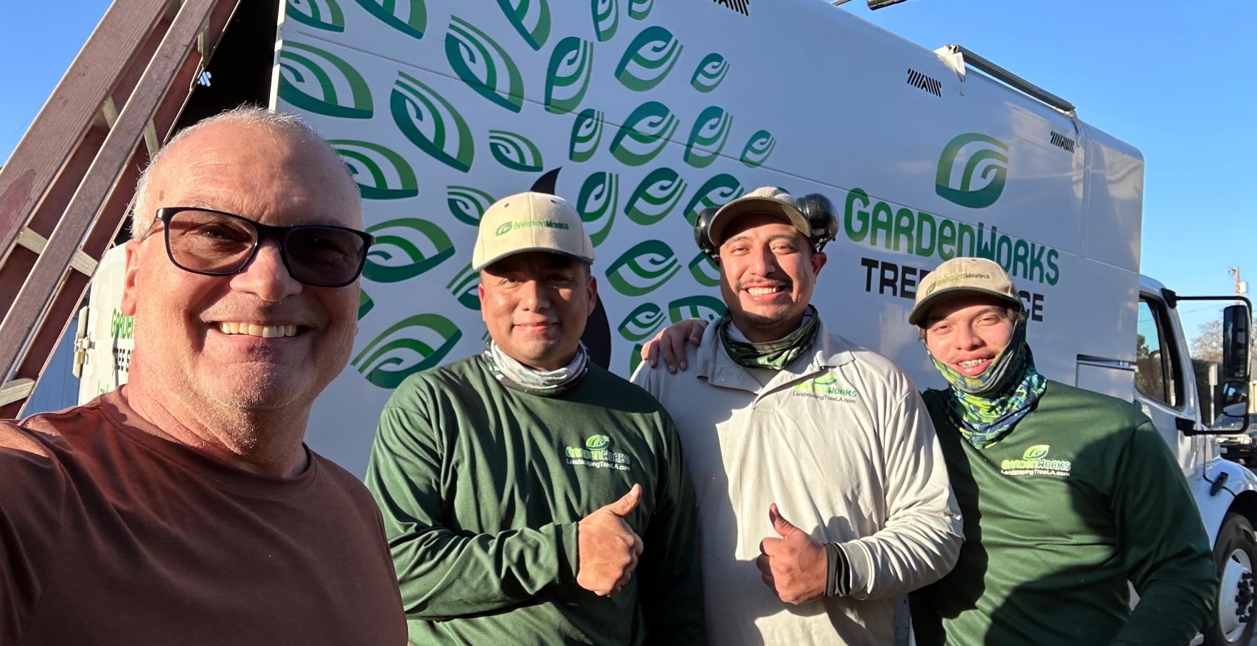 Jim Green taking a selfie with the Garden Works crew in front of their work truck